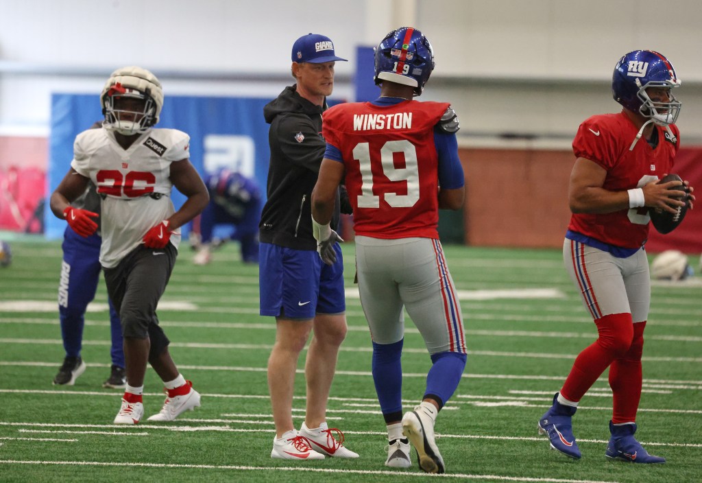 New York Giants Defensive Coordinator Charlie Bullen speaking with quarterback Jameis Winston during practice.