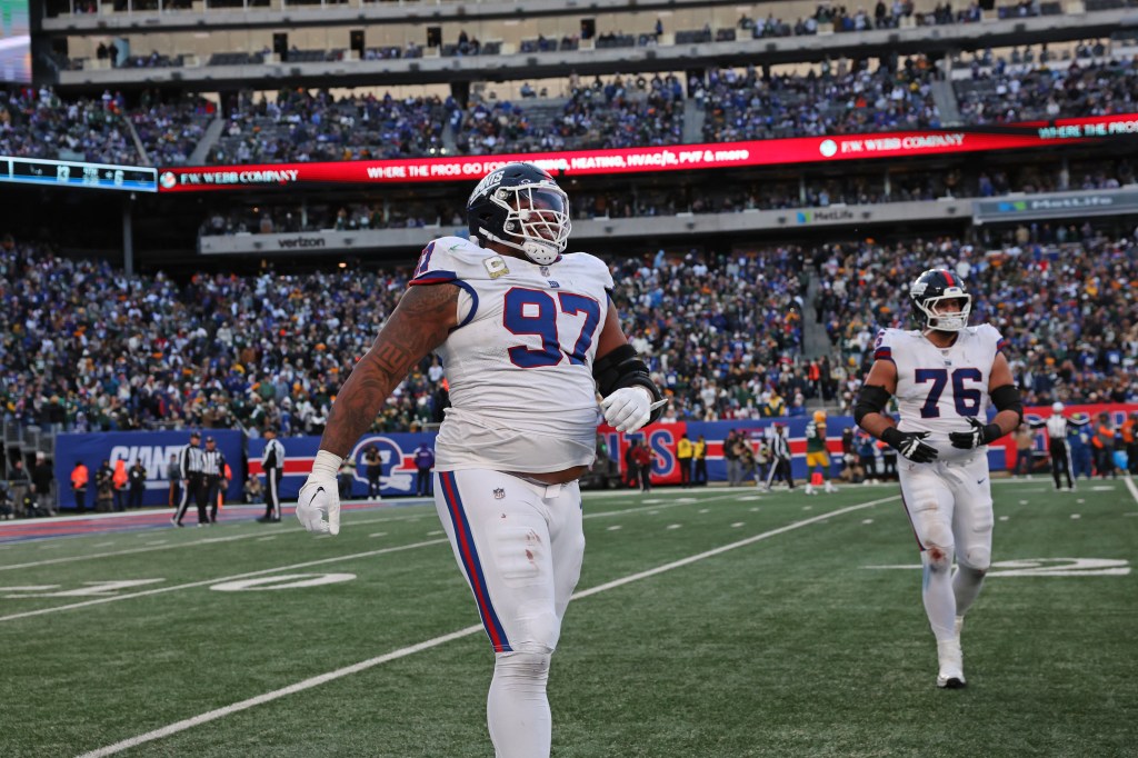 New York Giants defensive tackle Dexter Lawrence II (97) and guard Jon Runyan (76) walk off the field after a game against the Green Bay Packers.