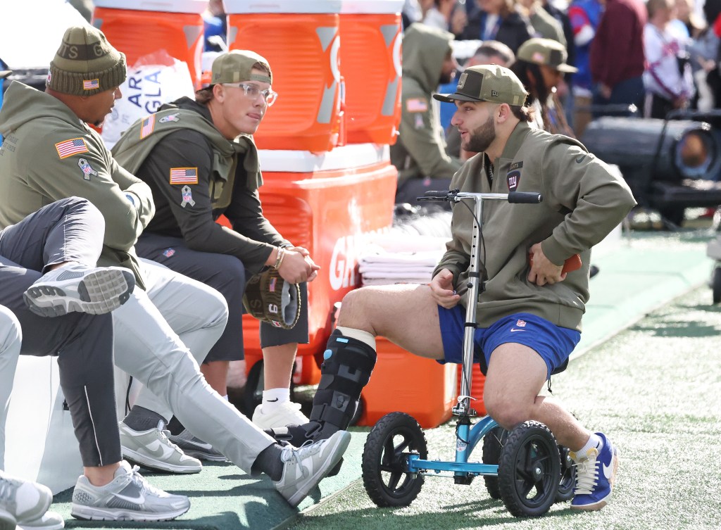 New York Giants quarterback Jaxson Dart (6) and running back Cam Skattebo (44) chat before the game against the Green Bay Packers.