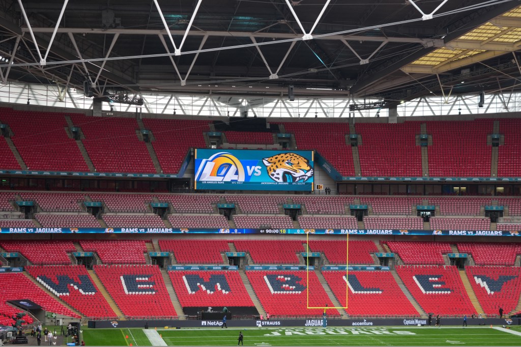 An empty Wembley Stadium in London, with a large screen showing the Los Angeles Rams versus the Jacksonville Jaguars.