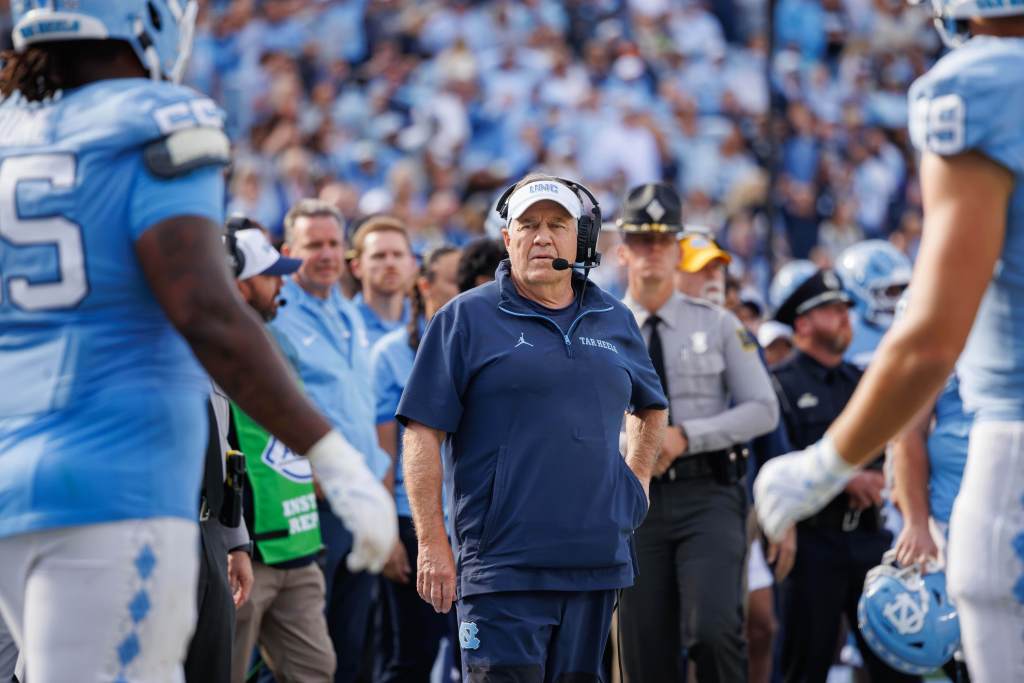 North Carolina head coach Bill Belichick on the field after a football game.