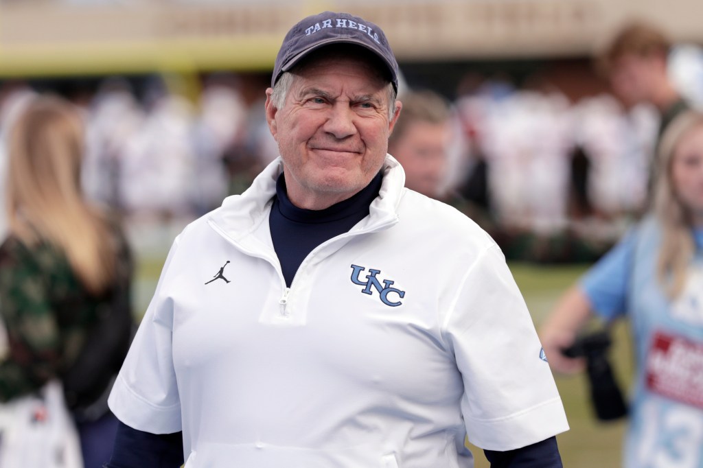North Carolina head coach Bill Belichick smiles on the sidelines.