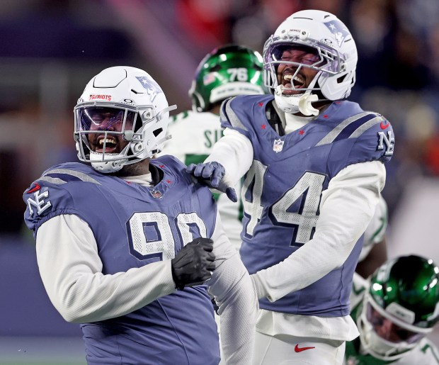 Foxboro, MA - Nov. 13 - New England Patriots linebacker K'Lavon Chaisson (44) celebrates efensive tackle Christian Barmore (90) sack on New York Jets quarterback Justin Fields during the second half at Gillette Stadium. (Photo By Matt Stone/Boston Herald).
