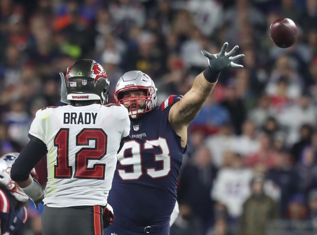 FOXBORO MA. - OCTOBER 3: Tampa Bay Buccaneers quarterback Tom Brady throws past New England Patriots defensive end Lawrence Guy during the 4th quarter of the game at Gillette Stadium on October 3, 2021 in Foxboro, MA. (Staff Photo By Nancy Lane/MediaNews Group/Boston Herald)