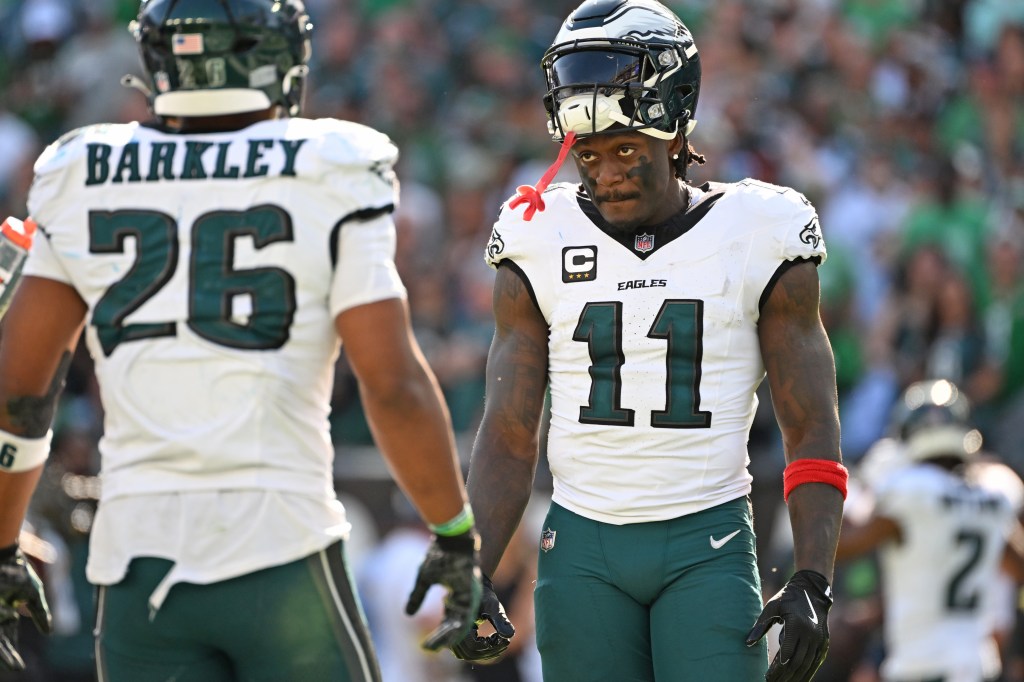 Philadelphia Eagles wide receiver A.J. Brown (11) and running back Saquon Barkley (26) on the field.