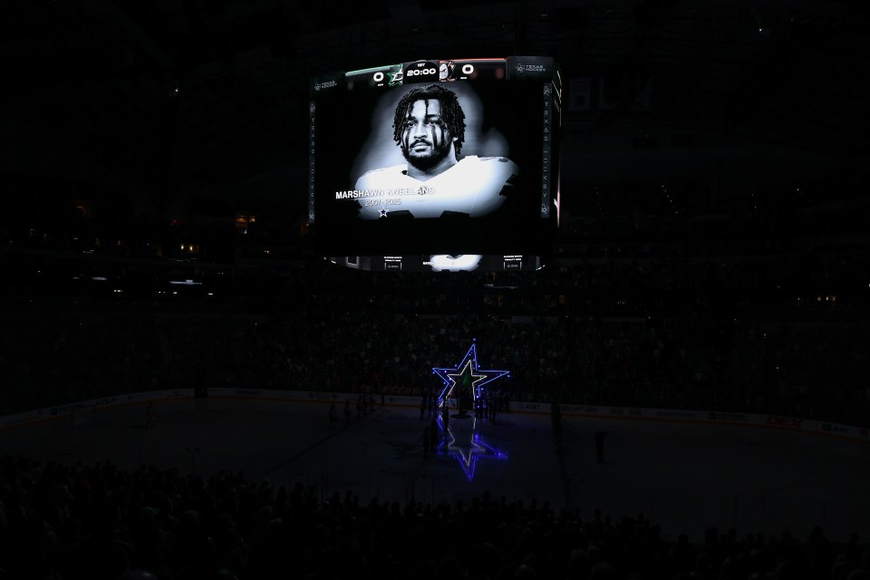 A remembrance of Marshawn Kneeland of the Dallas Cowboys is displayed on the arena screen prior to the game between the Dallas Stars and the Anaheim Ducks at American Airlines Center on November 06, 2025 in Dallas, Texas.