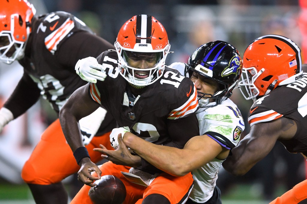 Cleveland Browns quarterback Shedeur Sanders (12) is sacked by Baltimore Ravens safety Kyle Hamilton (14) in the second half on Nov. 16, 2025.
