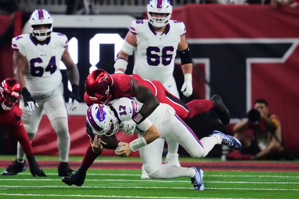 Houston Texans defensive end Will Anderson Jr. sacks Buffalo Bills quarterback Josh Allen.