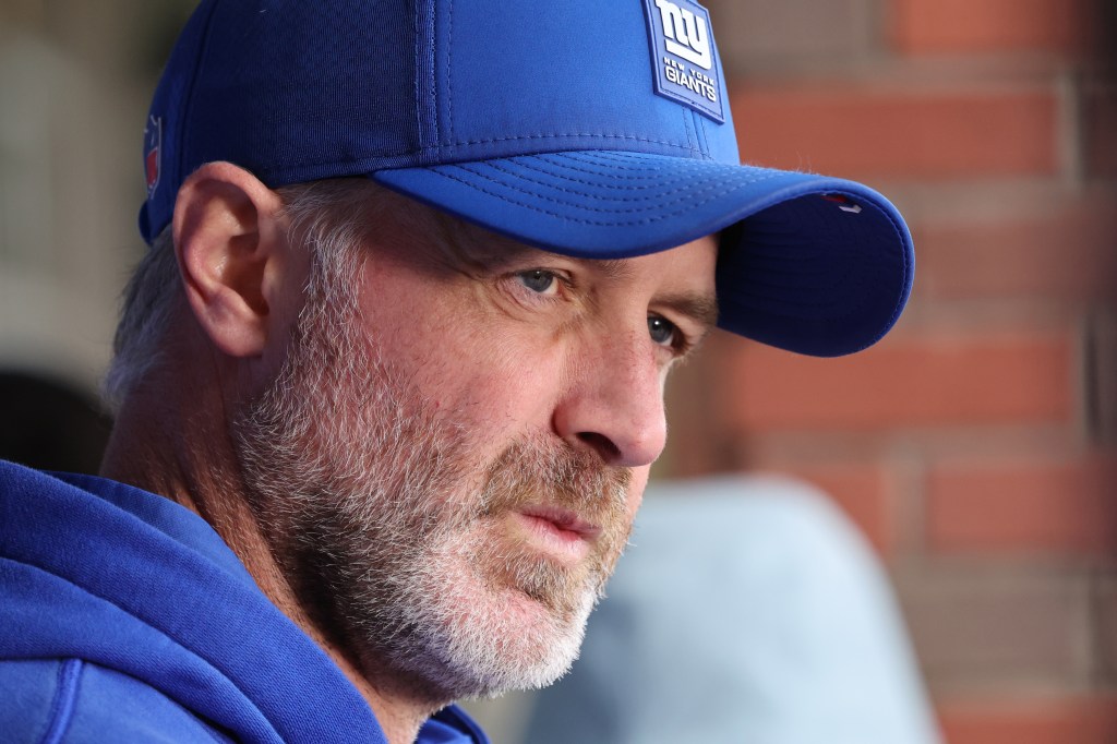 A man in a blue New York Giants hat looking to his right.