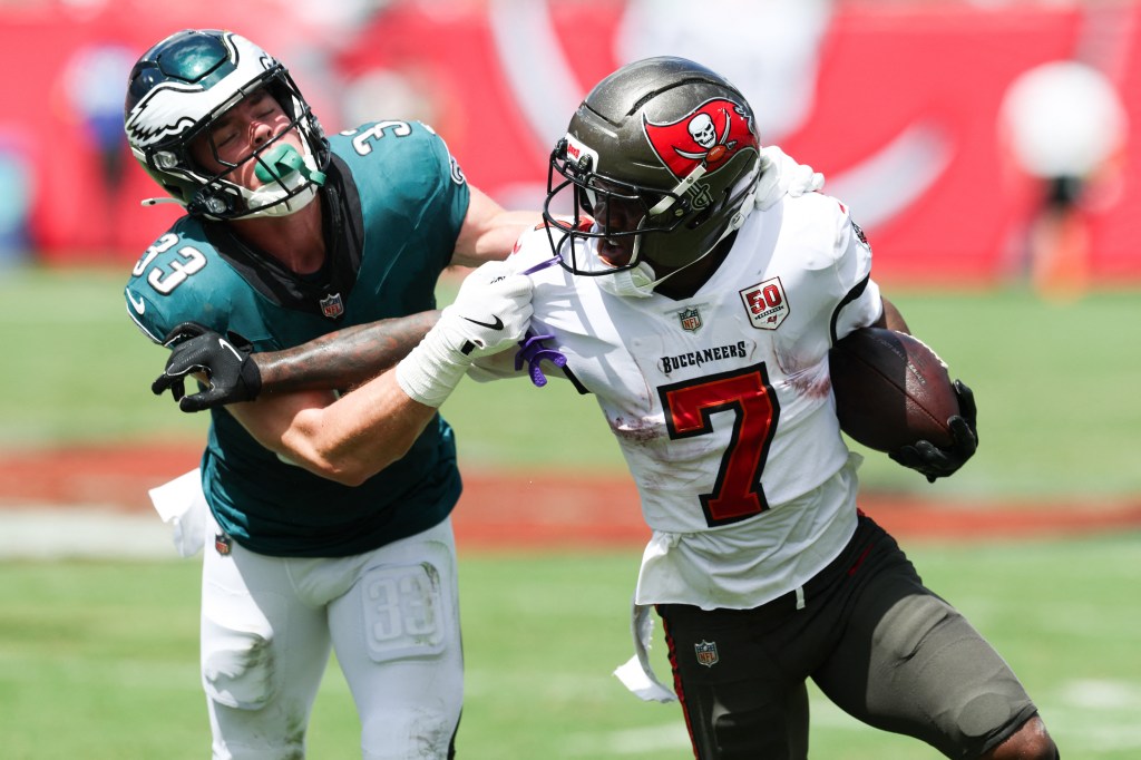 Tampa Bay Buccaneers running back Bucky Irving (7) attempts to stiff arm Philadelphia Eagles cornerback Cooper Dejean (33) during the first quarter at Raymond James Stadium on September 28, 2025. 