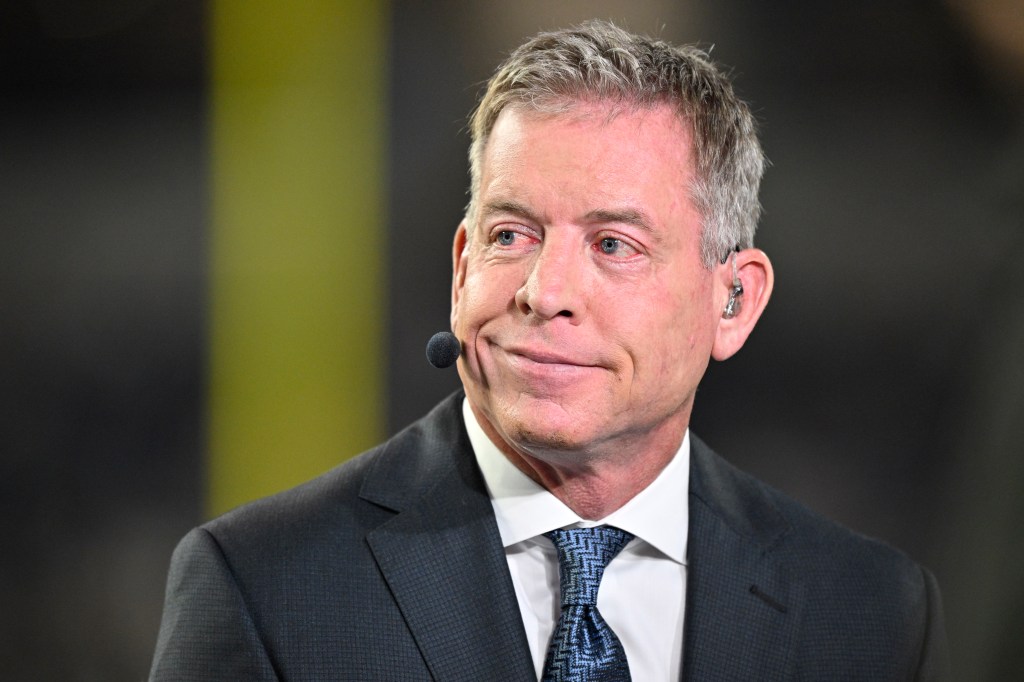 Television commentator Troy Aikman speaking before a football game.