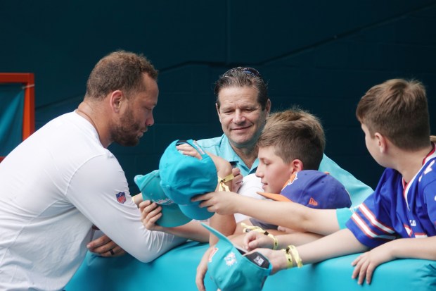 Miami Dolphins fullback Alec Ingold signs autographs before the game...