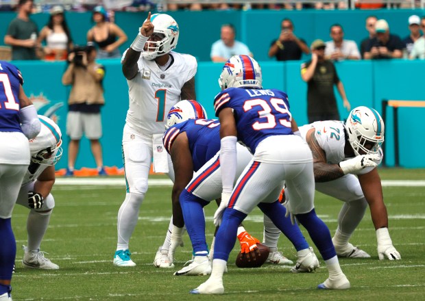 Miami Dolphins quarterback Tua Tagovailoa reacts to a penalty called...