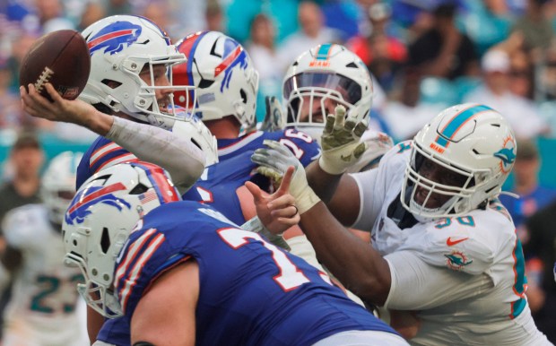 Buffalo Bills quarterback Josh Allen is pressured by Miami Dolphins...