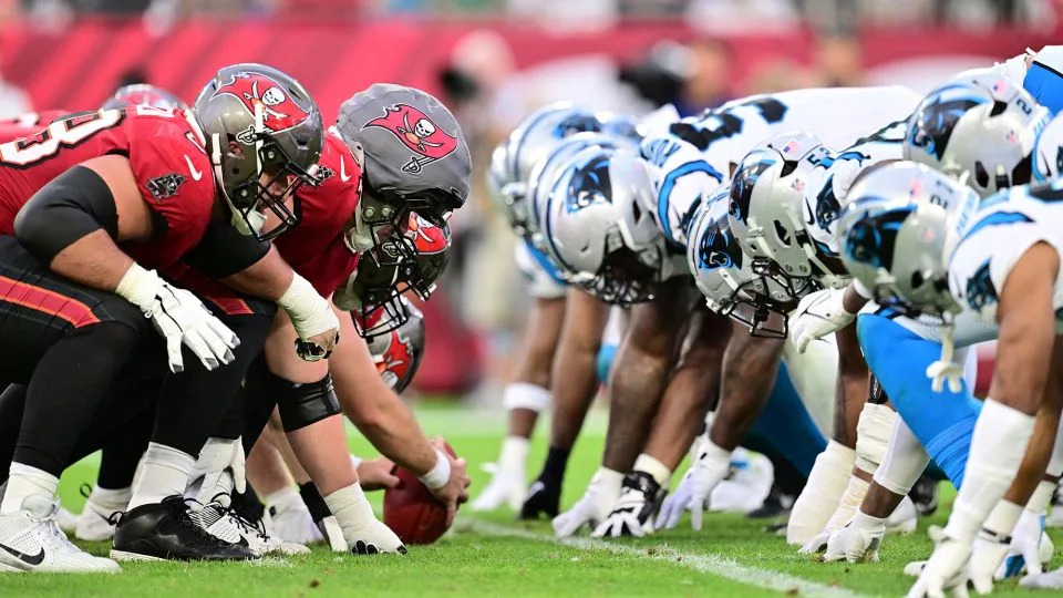 The Tampa Bay Buccaneers' offensive line lines up against the Carolina Panthers' D-line on December 29, 2024. - Julio Aguilar/Getty Images