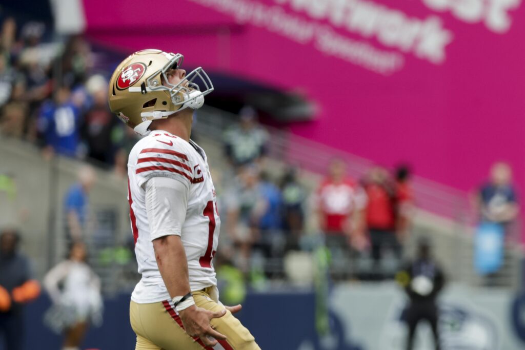San Francisco 49ers quarterback Brock Purdy (13) celebrates after throwing a touchdown pass against the Seattle Seahawks during the fourth quarter at Lumen Field.