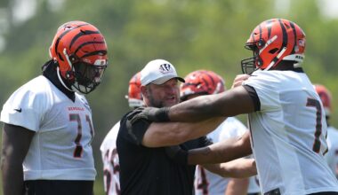 Jun 10, 2025; Cincinnati, OH, USA; Cincinnati Bengals offensive line coach Scott Peters (center) works with offensive tackle Amarius Mims (71) (left) and offensive tackle Caleb Etienne (77) )(right) during practice at Paycor Stadium. Mandatory Credit: Kareem Elgazzar-Imagn Images