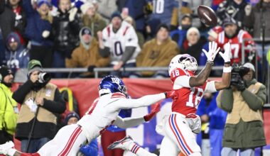 Dec 1, 2025; Foxborough, Massachusetts, USA; New England Patriots wide receiver Kyle Williams (18) catches a pass for a touchdown against New York Giants cornerback Paulson Adebo (21) during the second quarter at Gillette Stadium. Mandatory Credit: Eric Canha-Imagn Images
