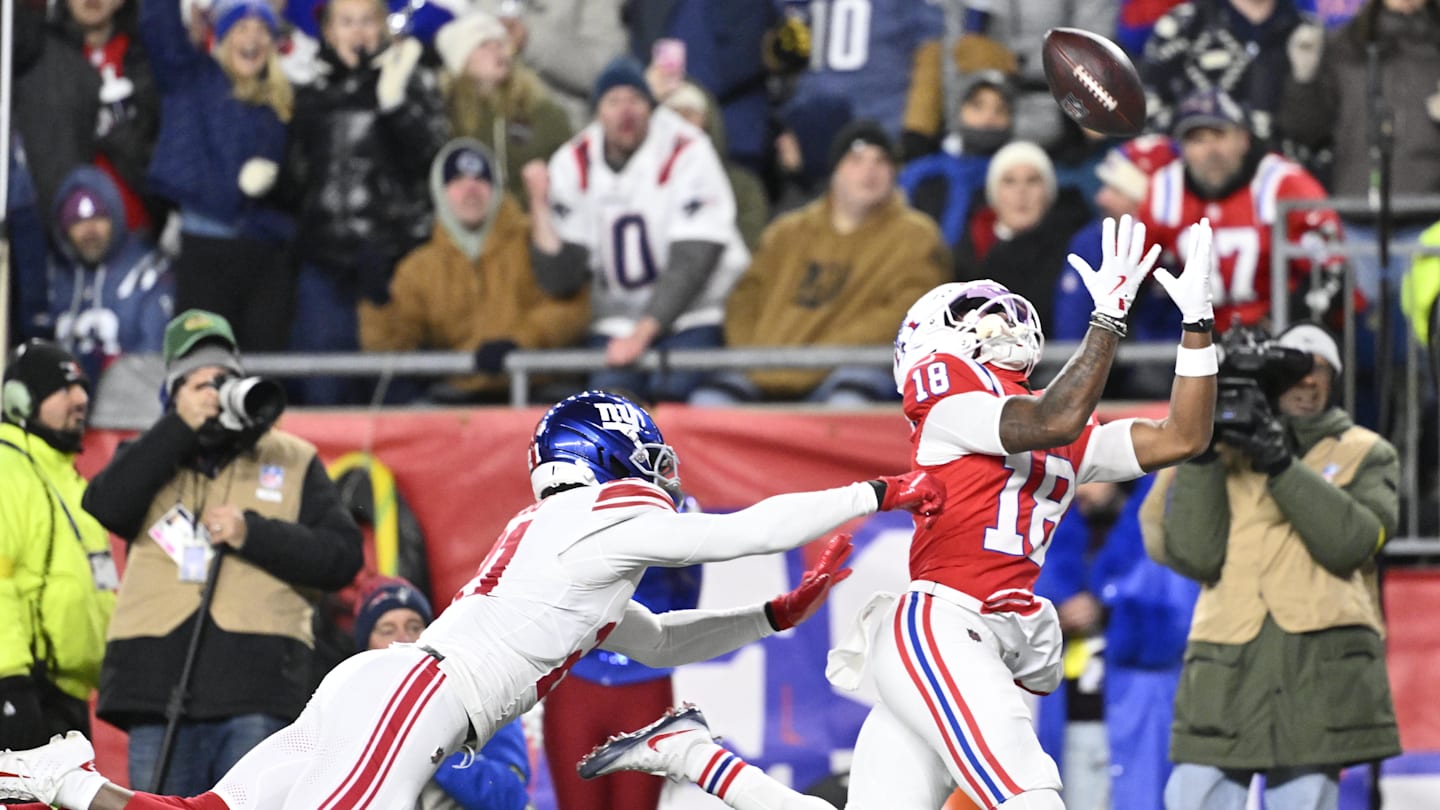 Dec 1, 2025; Foxborough, Massachusetts, USA; New England Patriots wide receiver Kyle Williams (18) catches a pass for a touchdown against New York Giants cornerback Paulson Adebo (21) during the second quarter at Gillette Stadium. Mandatory Credit: Eric Canha-Imagn Images