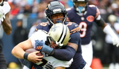 Oct 19, 2025; Chicago, Illinois, USA; Chicago Bears defensive end Dominique Robinson (90) makes a tackle for a loss on New Orleans Saints tight end Taysom Hill (7) during the second quarter at Soldier Field.