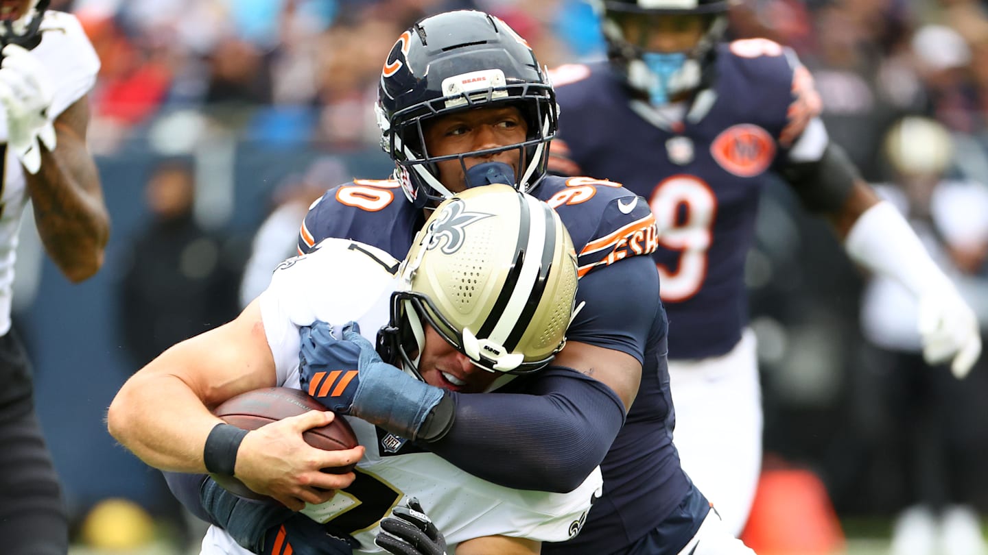 Oct 19, 2025; Chicago, Illinois, USA; Chicago Bears defensive end Dominique Robinson (90) makes a tackle for a loss on New Orleans Saints tight end Taysom Hill (7) during the second quarter at Soldier Field.