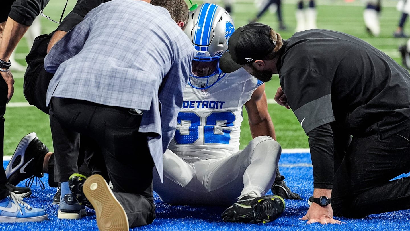 Detroit Lions head coach Dan Campbell, left, and staff check on the injury of safety Brian Branch (32) during the second half at Ford Field in Detroit on Thursday, Dec. 4, 2025.
