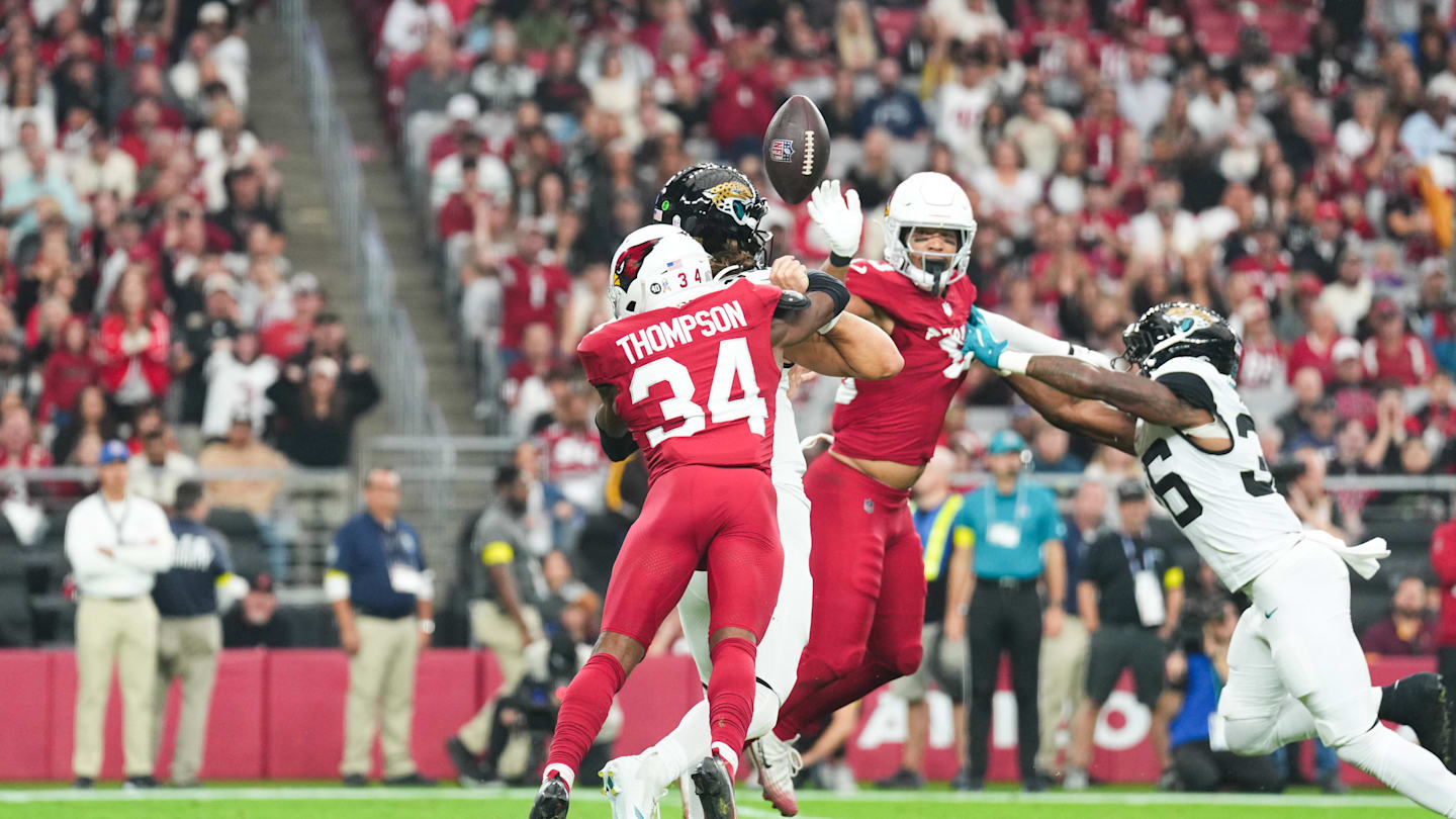 Nov 23, 2025; Glendale, Arizona, USA; Arizona Cardinals safety Jalen Thompson (34) forces a fumble from Jacksonville Jaguars quarterback Trevor Lawrence (16) during the first quarter at State Farm Stadium. Mandatory Credit: Joe Camporeale-Imagn Images
