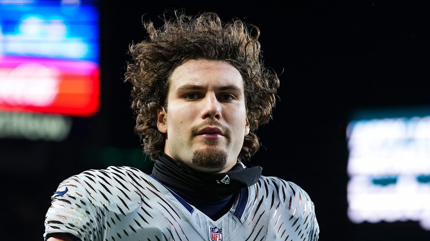 AJ Barner of the Seattle Seahawks runs onto the field