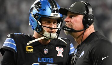 Dec 25, 2025; Minneapolis, Minnesota, USA; Detroit Lions quarterback Jared Goff (16) speaks with head coach Dan Campbell in the second quarter against the Minnesota Vikings at U.S. Bank Stadium.
