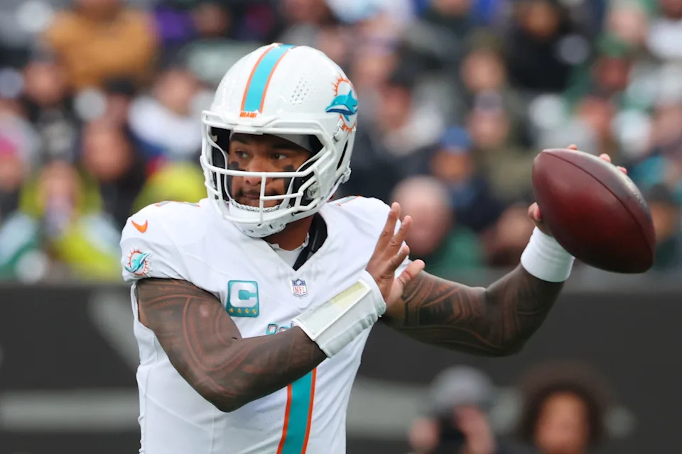 Dec 7, 2025; East Rutherford, New Jersey, USA; Miami Dolphins quarterback Tua Tagovailoa (1) passes the ball against the New York Jets during the first half at MetLife Stadium. Mandatory Credit: Ed Mulholland-Imagn Images