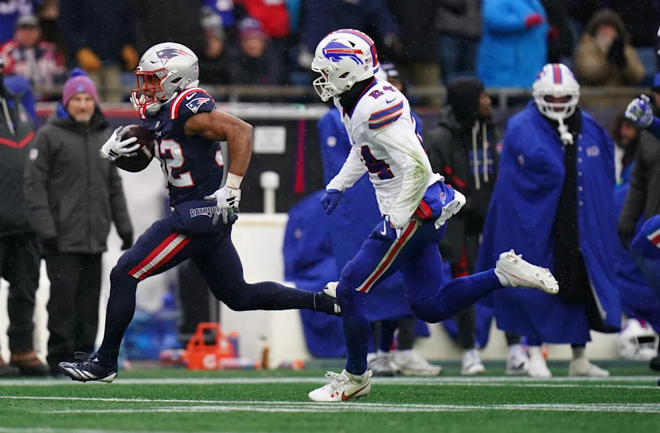 Dec 14, 2025; Foxborough, Massachusetts, USA; New England Patriots running back Treveyon Henderson (32) runs the ball for a touchdown against Buffalo Bills safety Cole Bishop (24) in the first half at Gillette Stadium. Mandatory Credit: David Butler II-Imagn Images