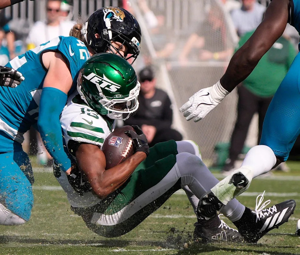 Jacksonville Jaguars safety Andrew Wingard (42) tackles New York Jets wide receiver Adonai Mitchell (15) in the first quarter during an NFL football game at EverBank Stadium, Sunday, Dec. 14, 2025, in Jacksonville, Fla. [Doug Engle/Florida Times-Union]