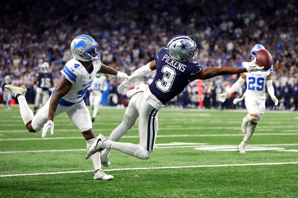 George Pickens #3 of the Dallas Cowboys drops a pass against D.J. Reed #4 of the Detroit Lions during the second quarter at Ford Field on December 04, 2025 in Detroit, Michigan