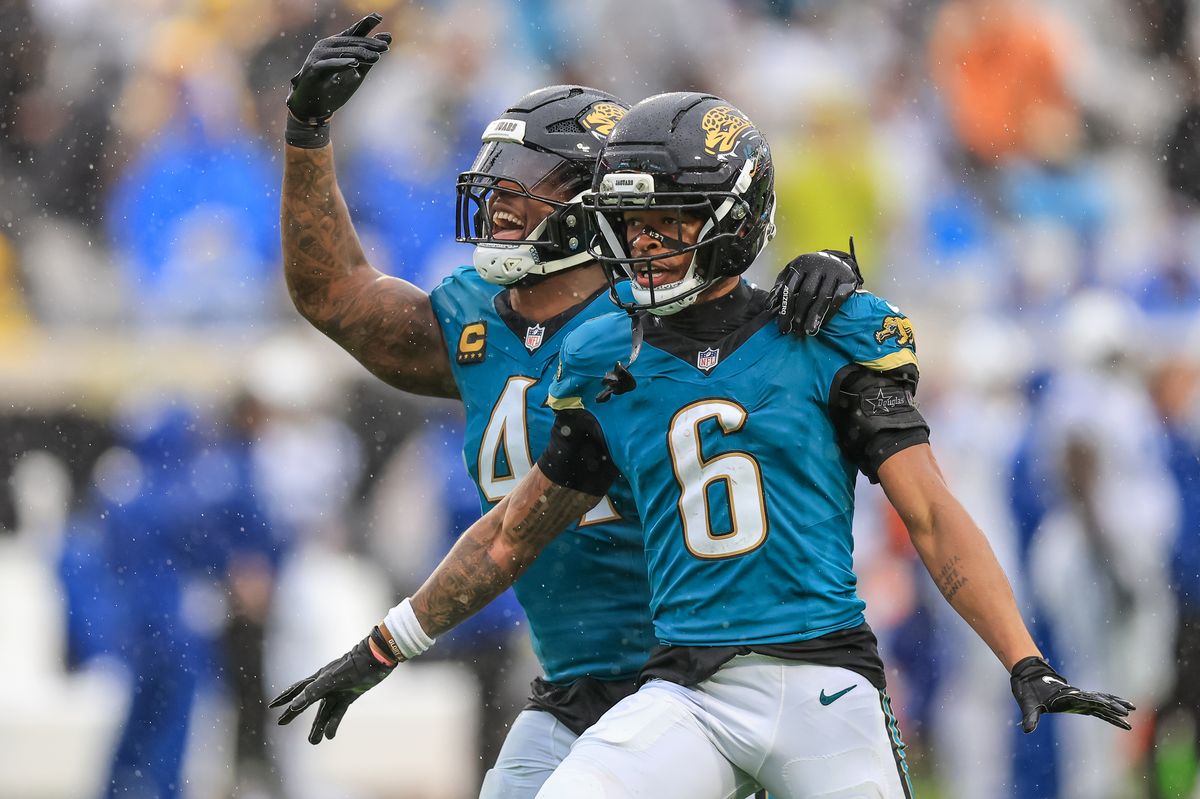Jaguars defensive players Josh Hines-Allen and Greg Newsome II celebrate after a play