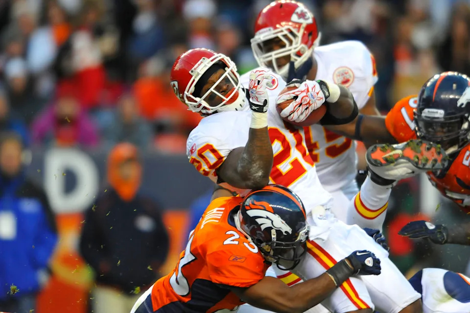 November 14, 2010; Denver, CO, USA; Kansas City Chiefs running back Thomas Jones (20) is denied a touchdown on a fourth and one by Denver Broncos safety Renaldo Hill (23) in the second half at Invesco Field. The Broncos defeated the Chiefs 49-29. Mandatory Credit: Ron Chenoy-USA TODAY Sports