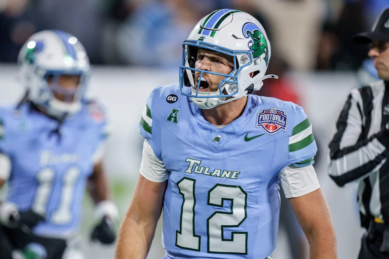Tulane quarterback Jake Retzlaff (12) reacts after a touchdown against North Texas during the first half of the American Conference championship NCAA college football game in New Orleans, Friday, Dec. 5, 2025. (AP Photo/Matthew Hinton)