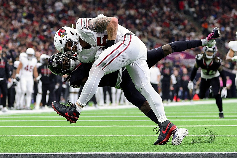 AP photo by Maria Lysaker / Arizona Cardinals tight end Trey McBride holds on to the ball for a catch while covered by Houston Texans safety Calen Bullock during last Sunday's game at NRG Stadium.