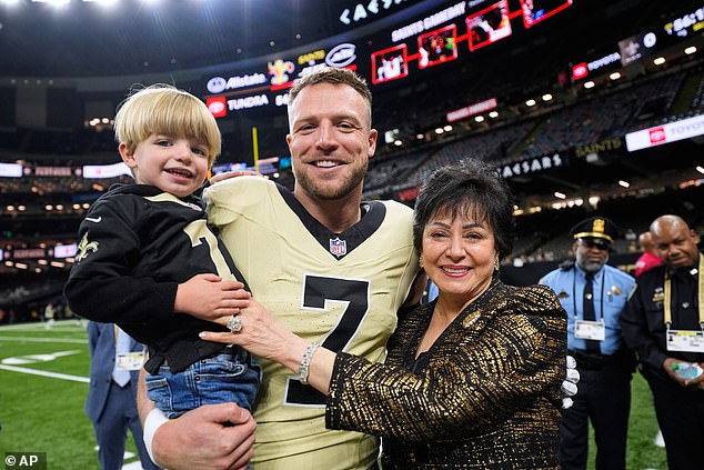 Mrs Benson is pictured with Saints tight end Taysom Hill and his son Bennett before a game
