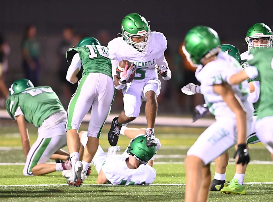 New Castle senior Tylin Thrine (5) leaps to avoid a tackle attempt during a football game against Yorktown Friday, Sept. 19, 2025, at Yorktown High School.