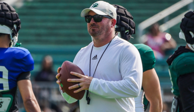 Ohio Football interim head coach John Hauser holding a ball at the team's Spring game in April.