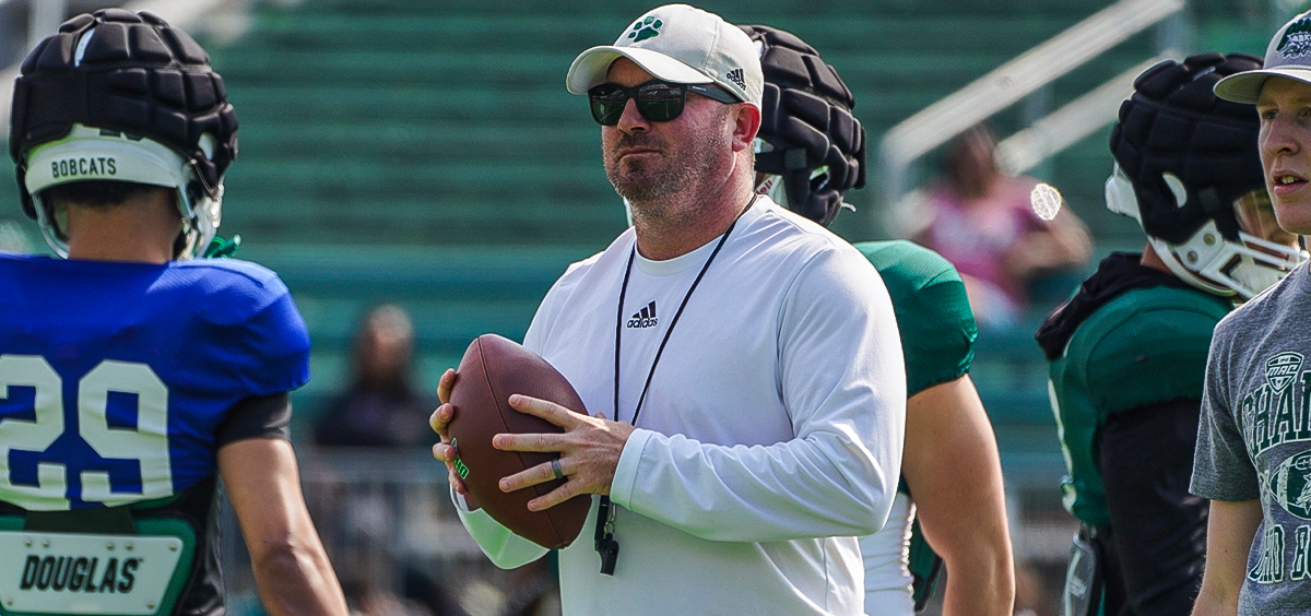 Ohio Football interim head coach John Hauser holding a ball at the team's Spring game in April.