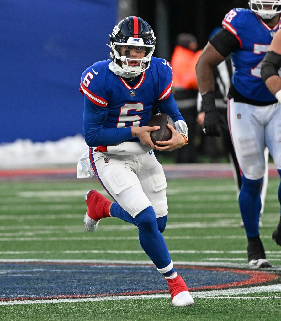 Quarterback Jaxson Dart #6 of the New York Giants is forced out of the pocket and runs the ball during the fourth quarter of the Giants and Washington Commanders game in East Rutherford, NJ.