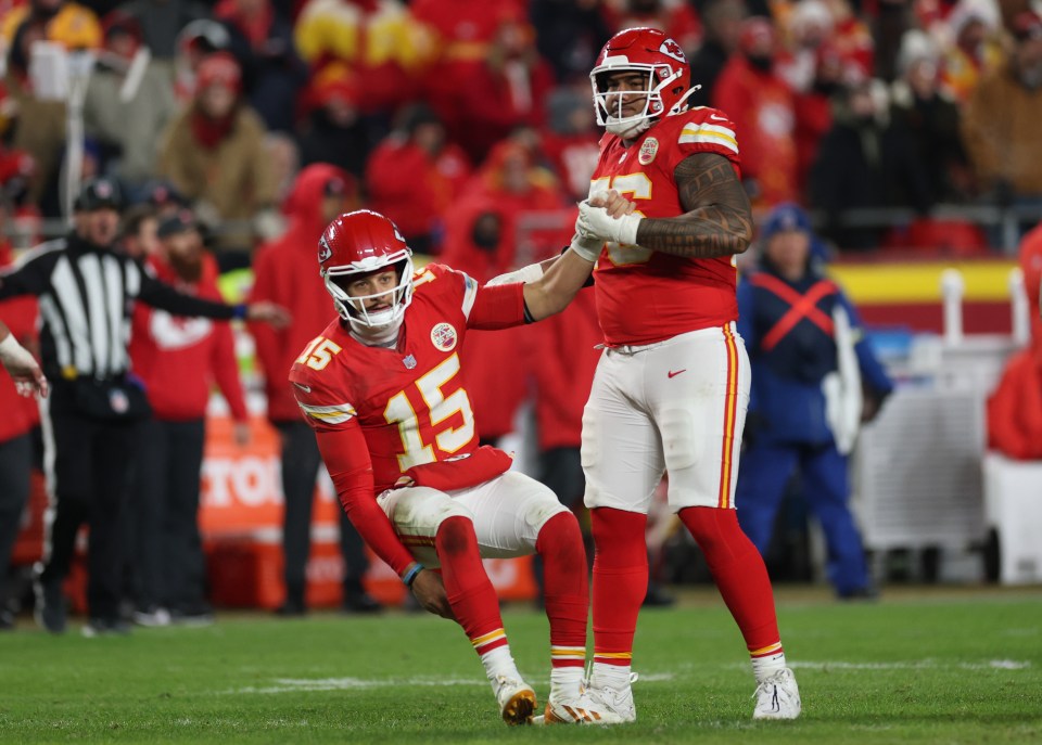 Patrick Mahomes #15 of the Kansas City Chiefs is helped up by Kingsley Suamataia #76 after an incomplete pass on fourth down against the Houston Texans