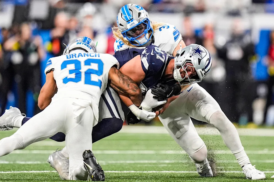 Detroit Lions safety Brian Branch (32) and linebacker Alex Anzalone (34) tackle Dallas Cowboys tight end Jake Ferguson (87) at Ford Field.Junfu Han-USA TODAY Network via Imagn Images
