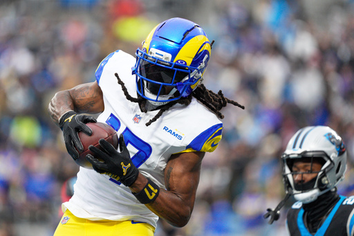 Los Angeles Rams wide receiver Davante Adams scores against the Carolina Panthers during the first half of an NFL football game, Sunday, Nov. 30, 2025, in Charlotte, N.C. (AP Photo/Jacob Kupferman)
