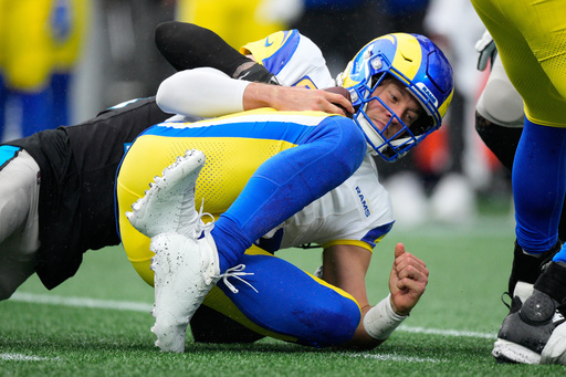 Los Angeles Rams quarterback Matthew Stafford is sacked by Carolina Panthers safety Lathan Ransom during the second half of an NFL football game, Sunday, Nov. 30, 2025, in Charlotte, N.C. (AP Photo/Jacob Kupferman)