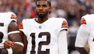 Shedeur Sanders #12 of the Cleveland Browns stands on the sidelines during the national anthem.