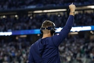 Dallas Cowboys head coach Brian Schottenheimer celebrates a touchdown on the sidelines...
