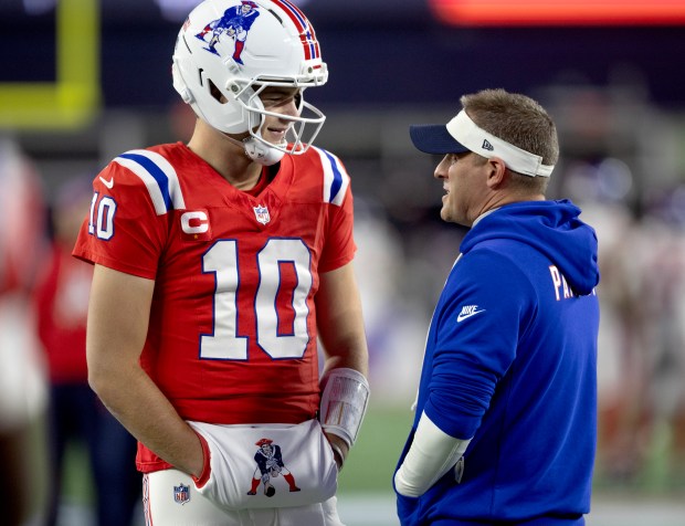 New England Patriots quarterback Drake Maye (10) talks with offensive coordinator Josh McDaniels before the NFL game against the New York Giants at Gillette Stadium on Monday night. (Photo By Matt Stone/Boston Herald)