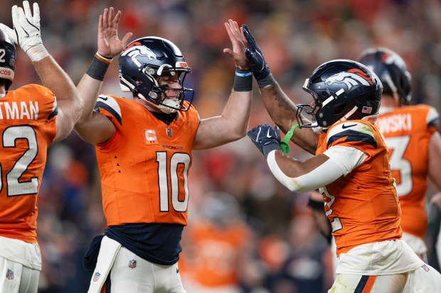 Running back RJ Harvey (12) of the Denver Broncos celebrates a touchdown run with quarterback Bo Nix (10) in a 34-26 win over the Green Bay Packers on Sunday, Dec. 14, 2025, at Empower Field at Mile High Stadium in Denver. (Photo by Timothy Hurst/The Denver Post)